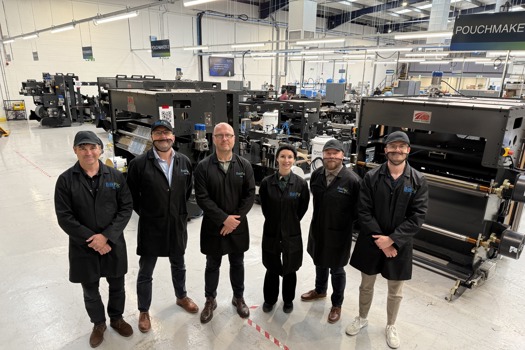 The company's management team with the five pouchmakers