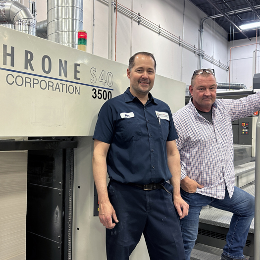 Dan Keylard (left) and Joe Engwall with the converted eight colour Komori LS40 press